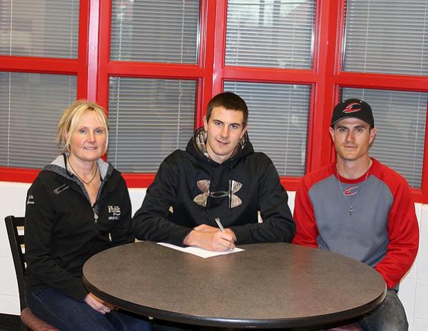 David Krauss, center, signs his letter of intent to play for the Express next year. Photo by Nicholas Huenefeld/Owens Sports Information