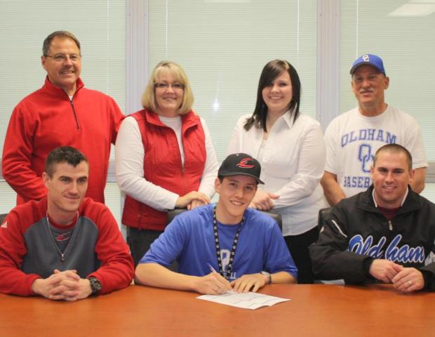 Zachary Bobbitt (front center) signs his letter of intent as he is joined by his parents, Mike and Mary Bobbitt, Chelsea Bobbitt, Tod Shafer, Express head coach Devin Taylor and Scott Gerlach. Photo by Jeff Elder