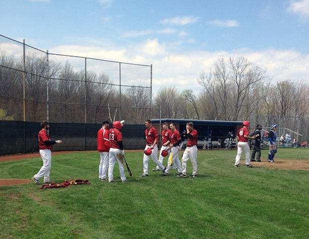 Anthony Perez (right of No. 13 Michael Finch) is greeted by his teammates after his fourth inning grand slam. Photo by Rudy Yovich/Owens Sports Information