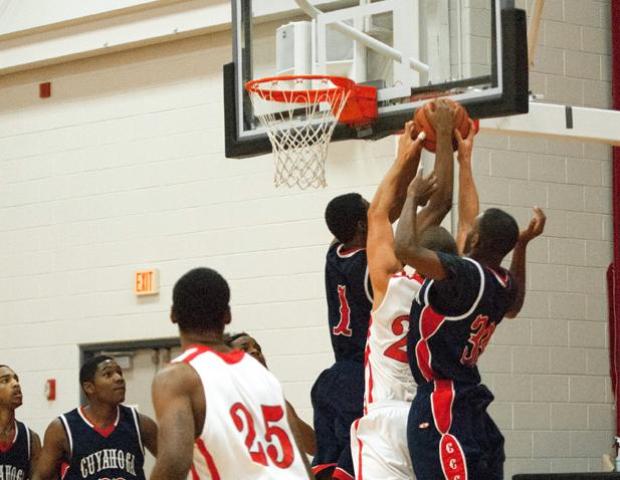 Jordan Basinger fights two Cuyahoga defenders for a loose ball. The sophomore finished with eight points and team highs in rebounds (7) and steals (4). Photo by Seth Foley