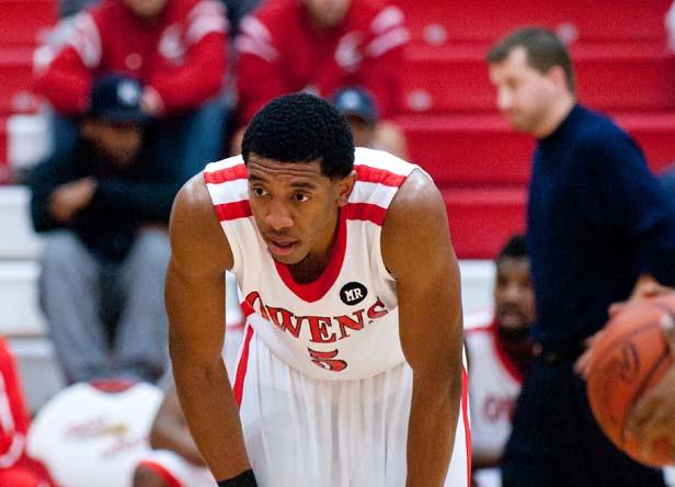 Sophomore Jerron Jamerson collects his thoughts before a free throw attempt as head coach Dave Clarke paces in the background. Photo by Seth Foley