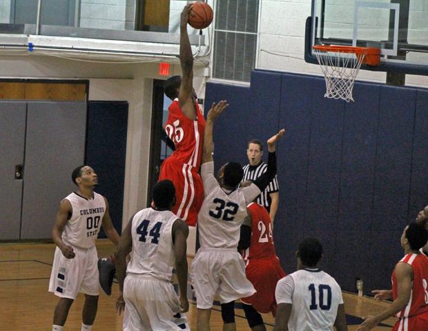 James Kelly throws down a monster dunk in traffic in today's 80-76 win over Columbus State. Photo by Nicholas Huenefeld/Owens Sports Information