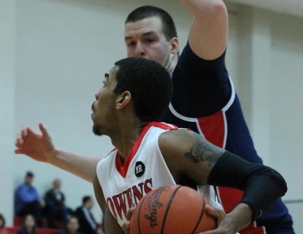 Joe Retic drives past a Cuyahoga defender in his team's 74-40 win in the SHAC tonight. Photo by Dave Harrand/Owens Sports Information