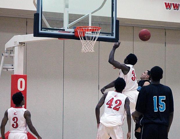 Tony Boykins (far right) blocks a shot attempt late in tonight's 117-109 loss to Kalamazoo Valley. The sophomore had 20 points and 11 rebounds (10 offensive) to lead the Express effort. Photo by Nicholas Huenefeld/Owens Sports Information