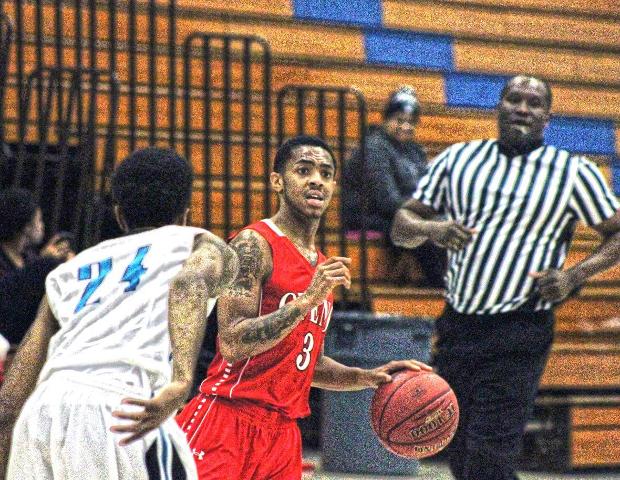 Justin Baker checks out the Cuyahoga defense in last night's 81-67 win. Photo by Nicholas Huenefeld/Owens Sports Information