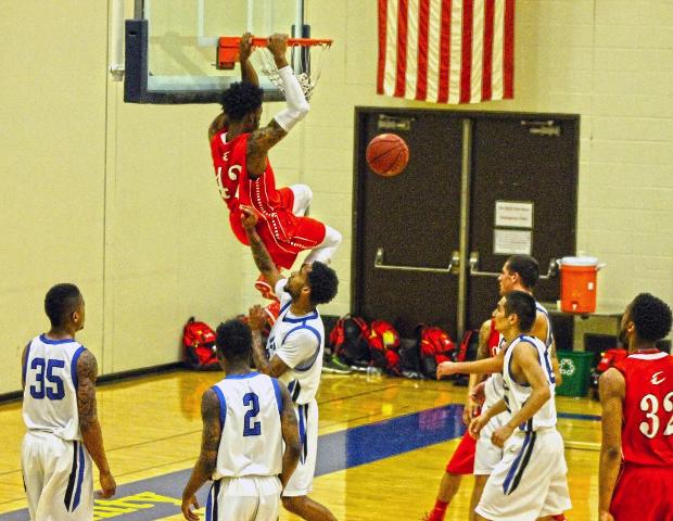 Kenny Jones throws down one of his four dunks in today's game. Photo by Nicholas Huenefeld/Owens Sports Information