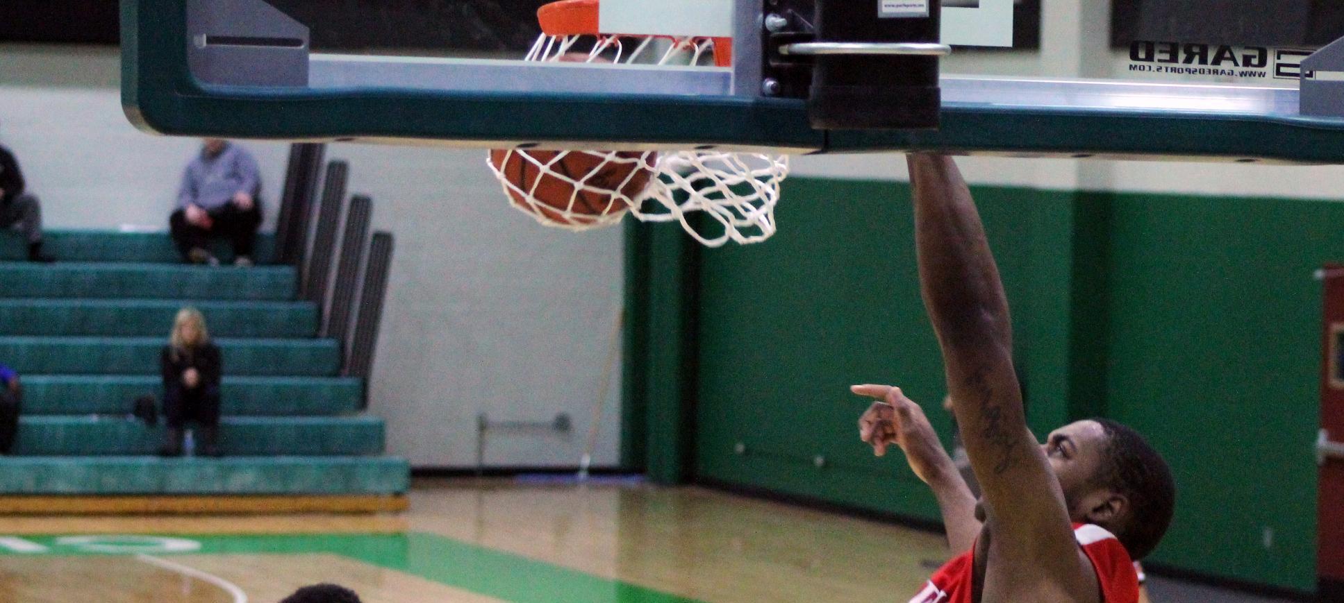 James Kelly throws down an alley-oop dunk with his left hand during the district championship game in 2013. Photo by Nicholas Huenefeld/Owens Sports Information