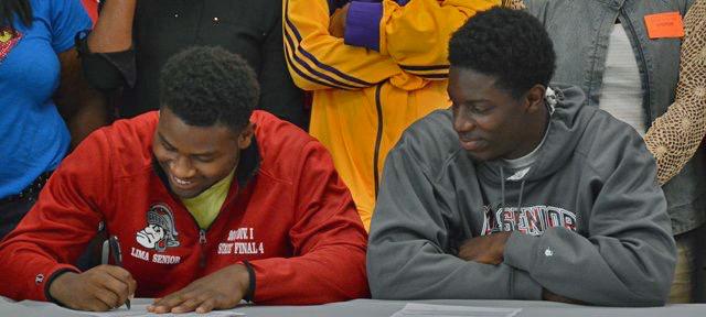 Rico Stafford looks on as Marquavious Wilson signs his LOI.
