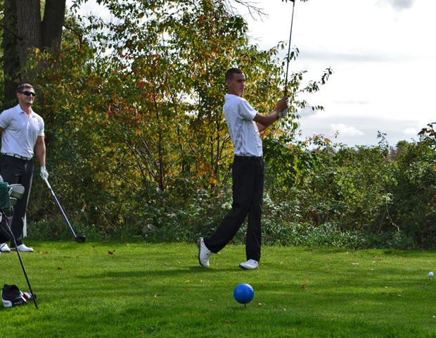 Brandon Hoelzer, right, checks out his shot as Jason Glass looks on. The duo was the lowest scoring in the Ken Venturi Invitational at Trine University this weekend. Photo by Josh Williams/Owens Sports Information