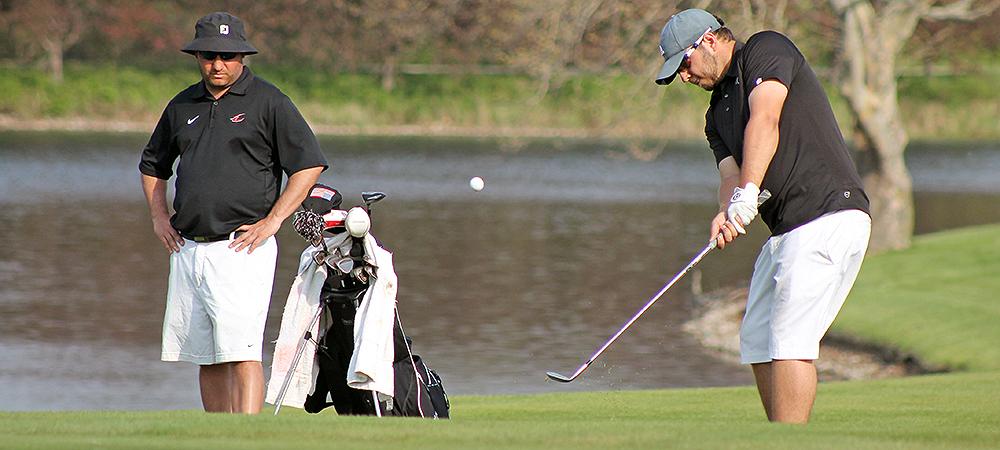 Dru Hein attempts a shot while head coach Josh Williams looks on. Photo by Nicholas Huenefeld/Owens Sports Information