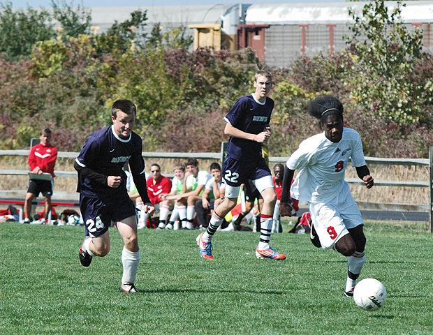 Juavanie Cole advances the ball past two Lorain County defenders. The sophomore, who was named the OCCAC Player of the Week, scored five goals in two games this week as the Express men's soccer team improved to 9-2-1 overall. Photo by Nicholas Huenefeld/Owens Sports Information