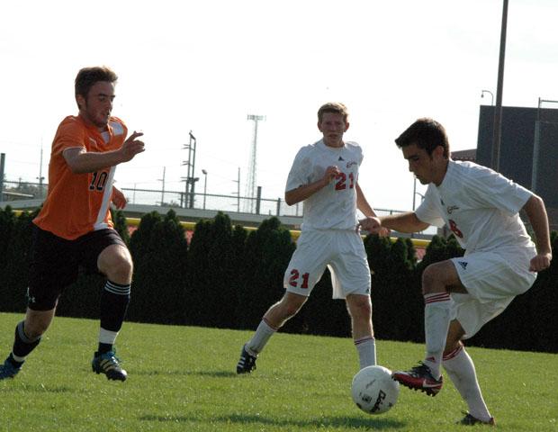 Chris Kervick looks to make a move on a Morton College defender as Tyler Kortokrax (21) looks on. Photo by Nicholas Huenefeld/Owens Sports Information