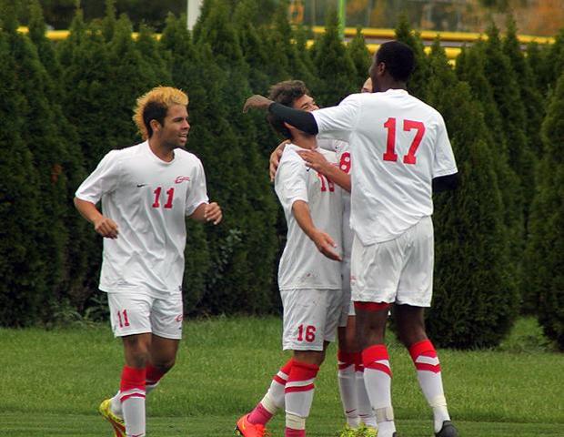 Matt Almester (18) is congratulated by his teammates Alejandro Salinaz (11), Trae Green (17) and Reiss Liggitt (8) after his second goal of the game put Owens up 2-0. Photo by Nicholas Huenefeld/Owens Sports Information