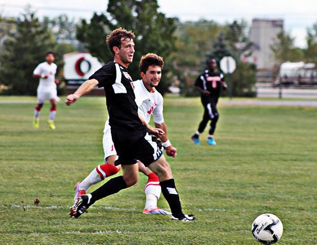 Matt Almester beats a Lake Michigan defender to put the ball in the right corner of the net in today's match. It was the team's fourth goal of the game. Photo by Nicholas Huenefeld/Owens Sports Information