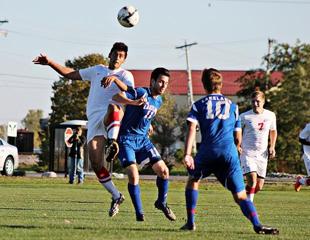 Ahmad Jarrar battles for a ball in the air in today's 6-0 win over Lakeland. The sophomore netted two goals and produced one assist. Photo by Nicholas Huenefeld/Owens Sports Information
