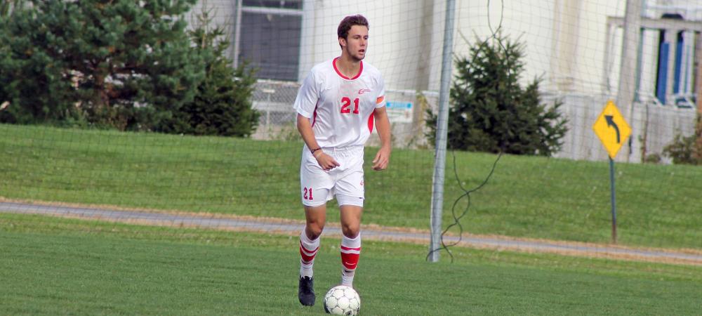 Cooper Huslig looks to move the ball during a game against Cuyahoga this past season. Photo by Nicholas Huenefeld/Owens Sports Information