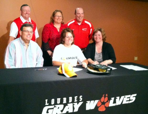 Kasey Graham, front center, signs her letter of intent to play at Lourdes University next season. Her parents are to her right and left, while the back row (L to R) is comprised of Express softball head coach Duane Lanham, Lourdes softball head coach Jo Ann Gordon and Express softball assistant coach Kevin Snyder. The photo below is of Graham during the team's spring trip earlier this season. Photos courtesy of Sharon Snyder/Owens Sports Information