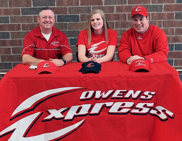 Bre Buck is joined by Express softball head coach Duane Lanham (left) and assistant coach Kevin Snyder (right) after signing her letter of intent today. Photo by Geoff Roberts/Owens Sports Information