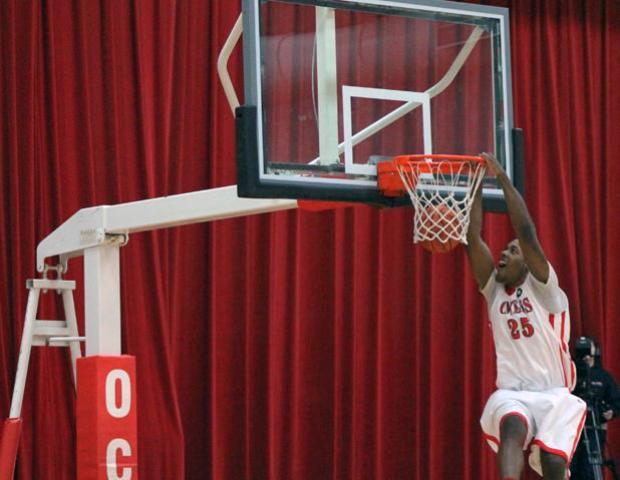 James Kelly, pictured here dunking the ball against Sinclair, was named the OCCAC men's basketball player of the week for the week ending Jan. 20. In two games against Cuyahoga and Cincinnati State, the sophomore produced a triple-double and a double-double. Photo by Dave Harrand/Owens Sports Information
