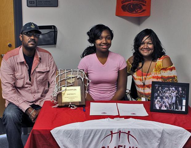 Karahn Scott poses with her parents, Donald and Lavera Scott, after signing her letter of intent to play for Claflin University next year. Photo by Nicholas Huenefeld/Owens Sports Information