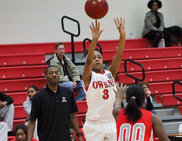 Zhana Randolph attempts a 3-pointer in front of Sinclair's bench in today's first half. The Express won 113-59 with Randolph scoring a season-high 13 points. Photo by Kyle Whitaker/Owens Sports Information
