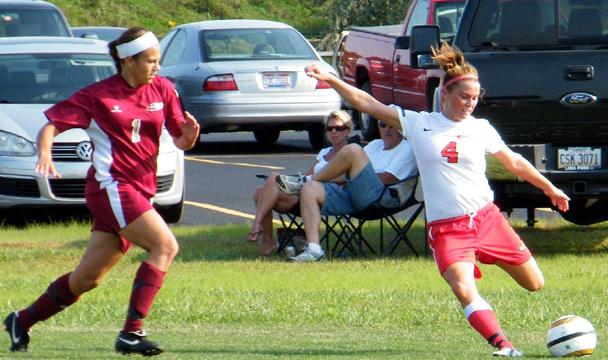 Marissa Szabo crosses the ball against Jackson CC. Photo by Nicholas Huenefeld