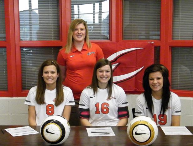 Express women's soccer head coach Mary Whisler stands near the first three recruits of her 2012-13 class. Far left is Taylor Avers of Woodmore HS, in the middle is Elizabeth Theaker of Maumee HS, and far right is Jessica Grindle of Northwood HS. Photo by Nicholas Huenefeld