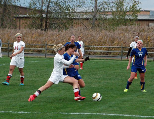 Jill Burkholder battles for the ball against a Muskegon defender as Kendra Eitniear (11) looks on. Both players scored a goal in the 3-0 win for the Express. Photo by Nicholas Huenefeld/Owens Sports Information