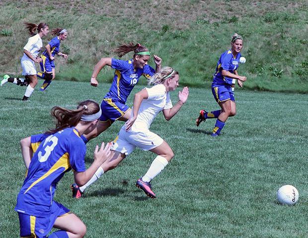 Jill Burkholder races past multiple Muskegon defenders in today's 2-1 win. Burkholder scored the game winner as the Express moved to 2-0. Photo by Nicholas Huenefeld/Owens Sports Information