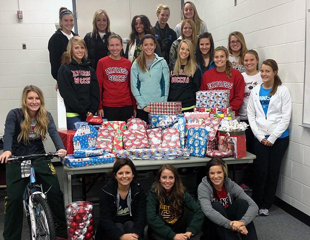 The Express women's soccer team, pictured here with the gifts they bought, adopted a local family for Christmas. It was the second consecutive year they've worked with the United Way on this project. Photo by Owens Sports Information