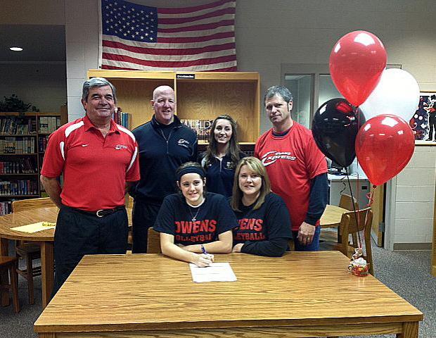Ciarra Wirick, front left, signs her letter of intent to play volleyball for the Express next year. Also pictured are her mom Diane Wirick (front row, right), Express volleyball head coach Sonny Lewis (back row, far left), Express volleyball assistant coach Denny Caldwell (back row, second from left), Benjamin Logan HS head coach Allison Reule (back row, second from right), and Ciara's dad, Dale Wirick (back row, far right). Photo courtesy of Owens Sports Information