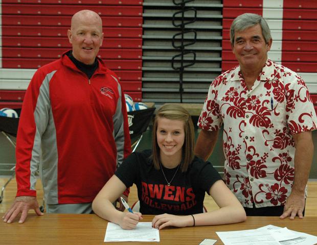 Stephanie Kipp signs her letter of intent as Express women's volleyball assistant coach Denny Caldwell (back left) and head coach Sonny Lewis (back right) look on. Photo by Nicholas Huenefeld/Owens Sports Information